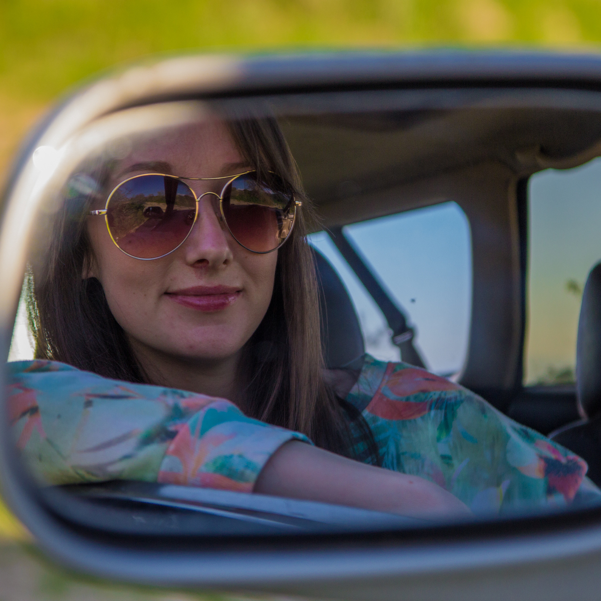 Woman in a car mirror